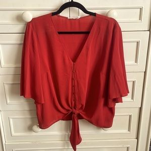 Lush size large warm orange top. Front tie.